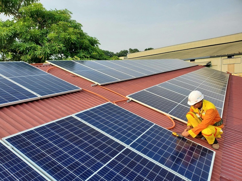 A technician fitting roof-mounted solar panels